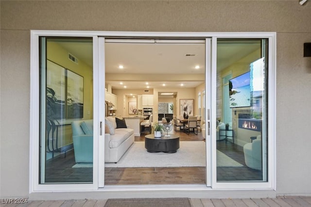 doorway to property with visible vents, a sink, and stucco siding