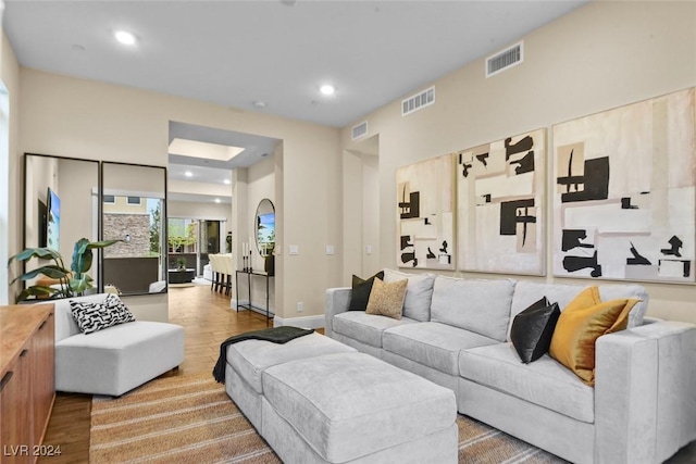 living area featuring wood finished floors, visible vents, and recessed lighting