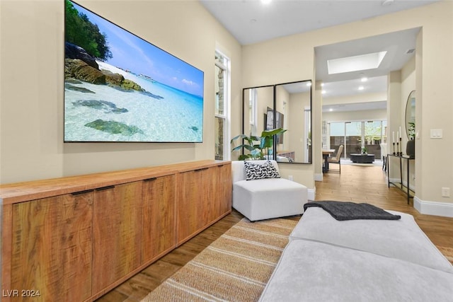 living area featuring wood finished floors and baseboards