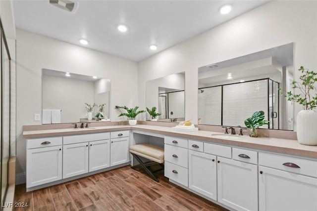 full bath featuring recessed lighting, a shower stall, wood finished floors, and vanity