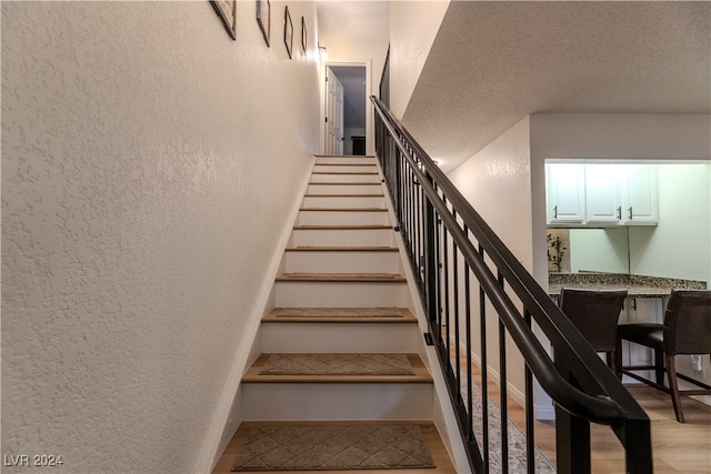 stairs with hardwood / wood-style floors