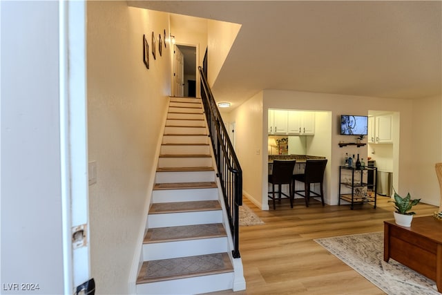 stairway with hardwood / wood-style floors