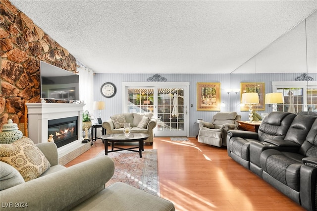 living room with light hardwood / wood-style flooring and a textured ceiling