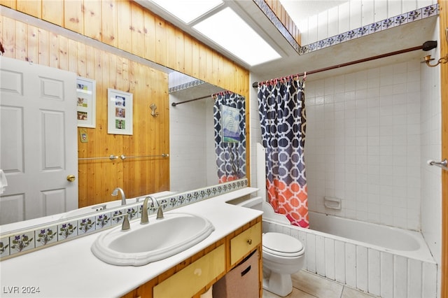 full bathroom with wood walls, tile patterned flooring, shower / tub combo, vanity, and toilet