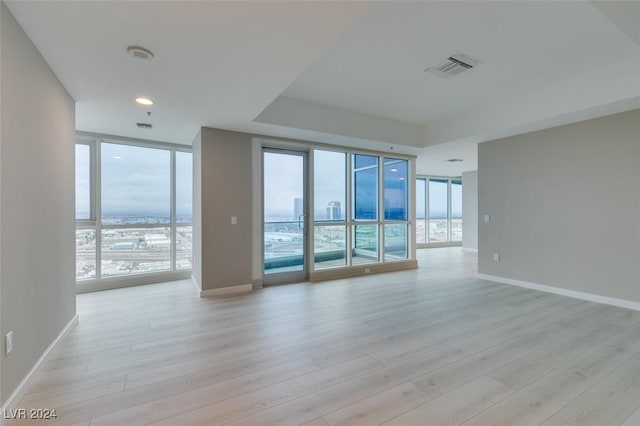 4525 Dean Martin Dr Unit 2704, Las Vegas, NV 89103 - unfurnished room with a wall of windows, light wood-type flooring, and baseboards