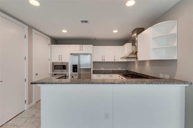 4525 Dean Martin Dr Unit 2704, Las Vegas, NV 89103 - kitchen with built in appliances, wall chimney exhaust hood, dark stone countertops, open shelves, and white cabinetry