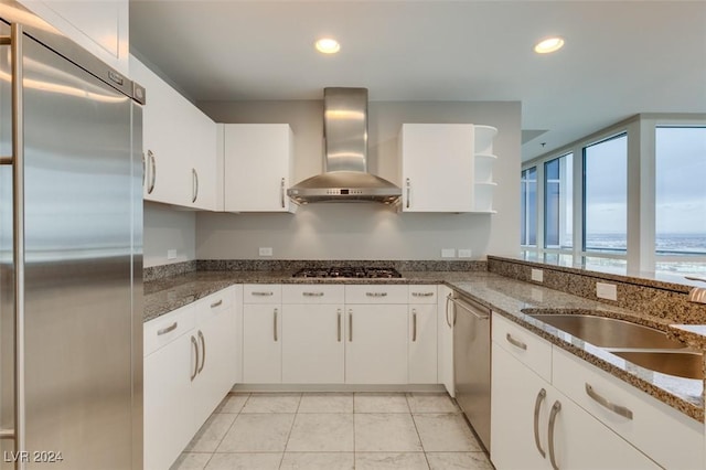 4525 Dean Martin Dr Unit 2704, Las Vegas, NV 89103 - kitchen with appliances with stainless steel finishes, wall chimney exhaust hood, a sink, white cabinets, and recessed lighting