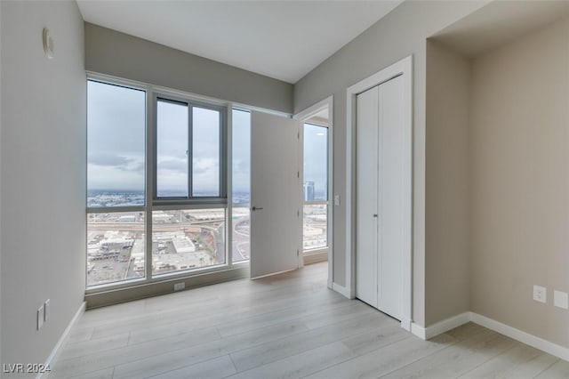 4525 Dean Martin Dr Unit 2704, Las Vegas, NV 89103 - unfurnished room featuring light wood-type flooring, plenty of natural light, and baseboards