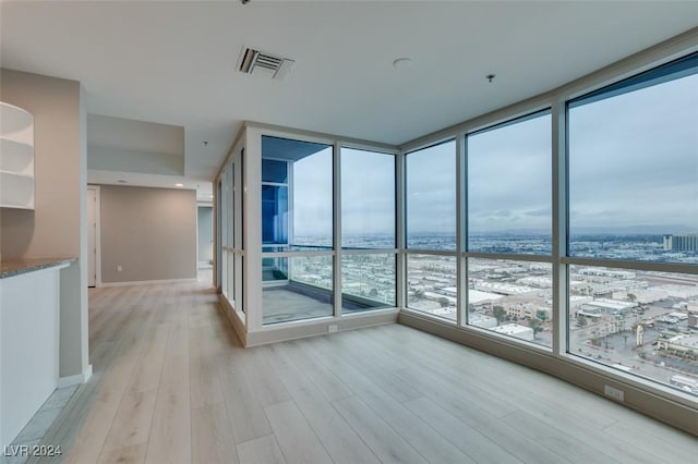 4525 Dean Martin Dr Unit 2704, Las Vegas, NV 89103 - unfurnished room featuring expansive windows, light wood-style floors, and baseboards