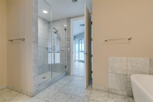 4525 Dean Martin Dr Unit 2704, Las Vegas, NV 89103 - full bathroom with a stall shower, marble finish floors, a freestanding tub, baseboards, and recessed lighting