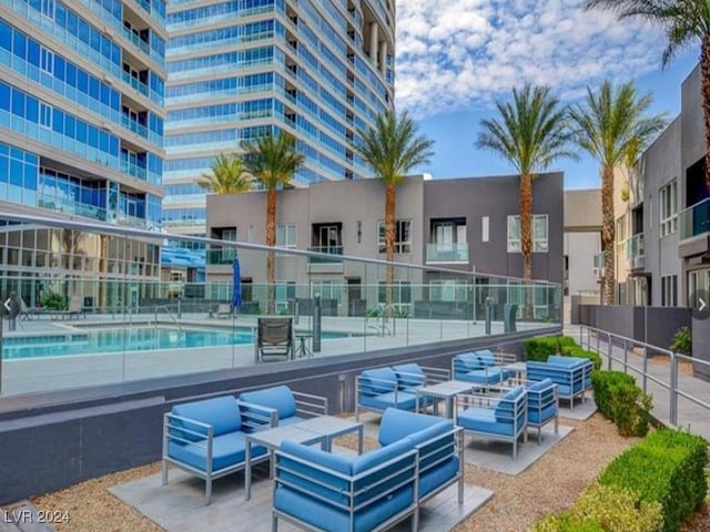 4525 Dean Martin Dr Unit 2704, Las Vegas, NV 89103 - view of patio / terrace with an outdoor living space, fence, and a community pool