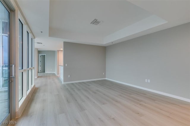 4525 Dean Martin Dr Unit 2704, Las Vegas, NV 89103 - empty room with a raised ceiling, light wood-style flooring, and baseboards