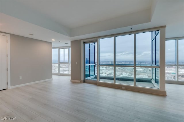 4525 Dean Martin Dr Unit 2704, Las Vegas, NV 89103 - unfurnished room with light wood finished floors, baseboards, expansive windows, and recessed lighting
