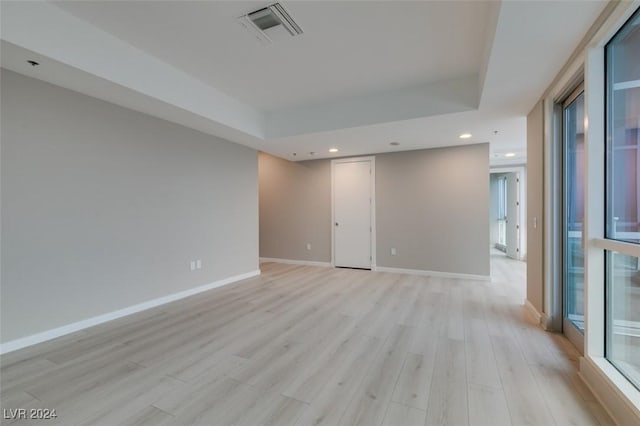 4525 Dean Martin Dr Unit 2704, Las Vegas, NV 89103 - unfurnished room featuring light wood-style floors, a raised ceiling, baseboards, and recessed lighting