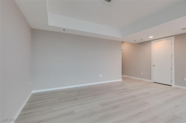 4525 Dean Martin Dr Unit 2704, Las Vegas, NV 89103 - spare room with light wood-style flooring, baseboards, recessed lighting, and a raised ceiling