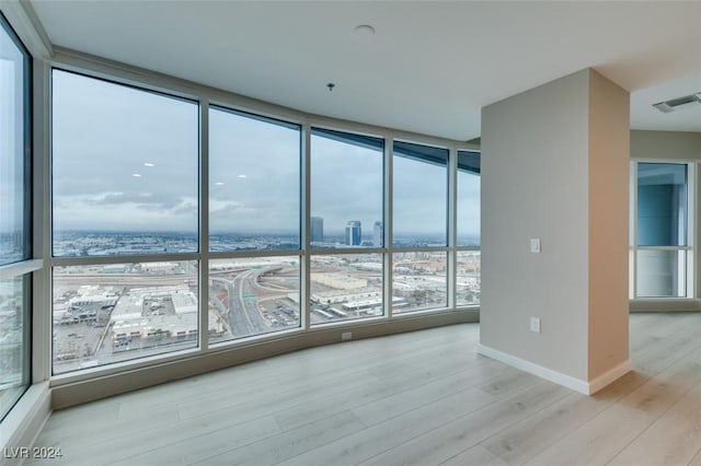 4525 Dean Martin Dr Unit 2704, Las Vegas, NV 89103 - spare room featuring light wood-style flooring, baseboards, and floor to ceiling windows