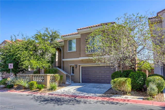 mediterranean / spanish-style home with a garage