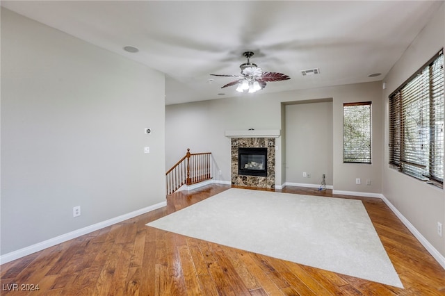 unfurnished living room with wood-type flooring and ceiling fan