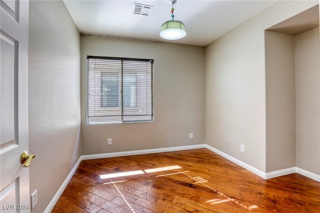 spare room with wood-type flooring