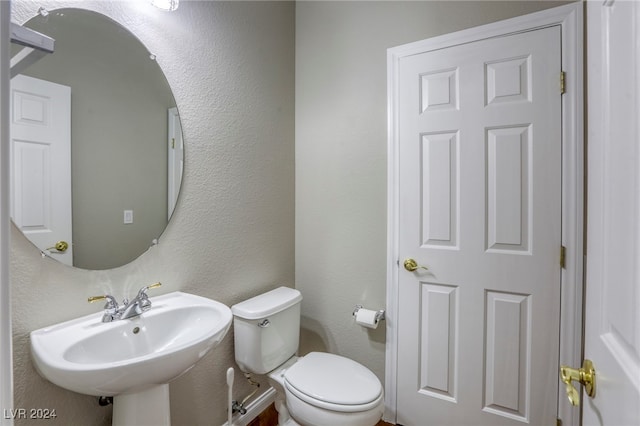 bathroom with toilet and sink