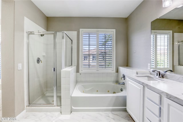 bathroom with vanity, a healthy amount of sunlight, and separate shower and tub