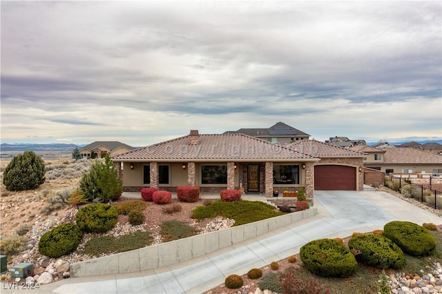 view of front of home featuring a garage and a porch