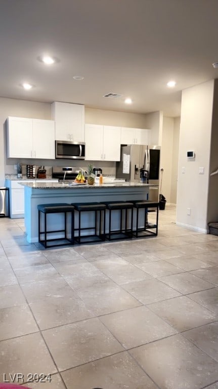 kitchen with white cabinetry and appliances with stainless steel finishes