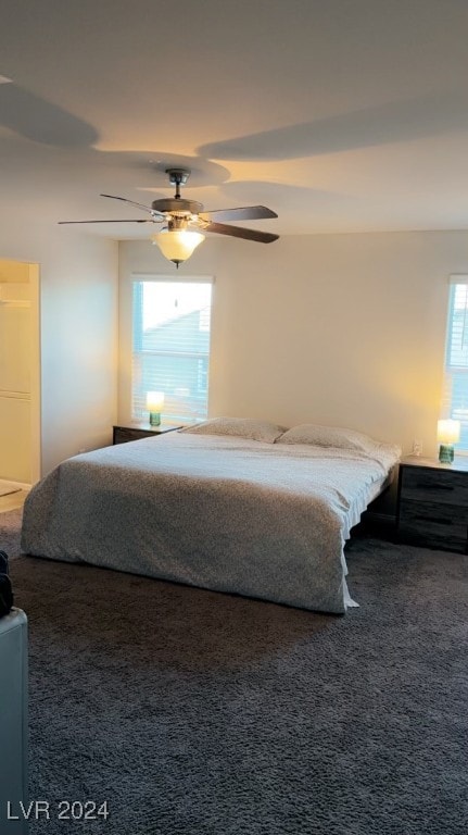 carpeted bedroom with ceiling fan and multiple windows