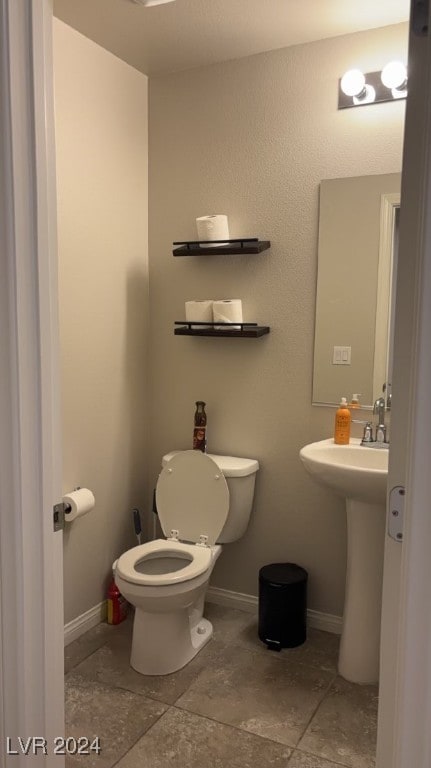 bathroom with tile patterned floors, toilet, and sink