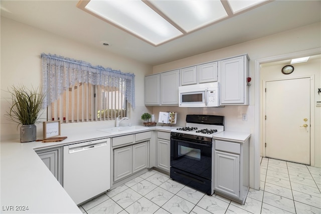 kitchen featuring white appliances and sink