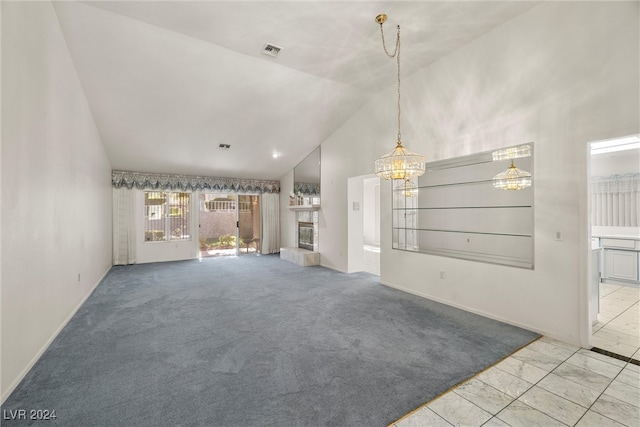 unfurnished living room with light colored carpet, a chandelier, and high vaulted ceiling