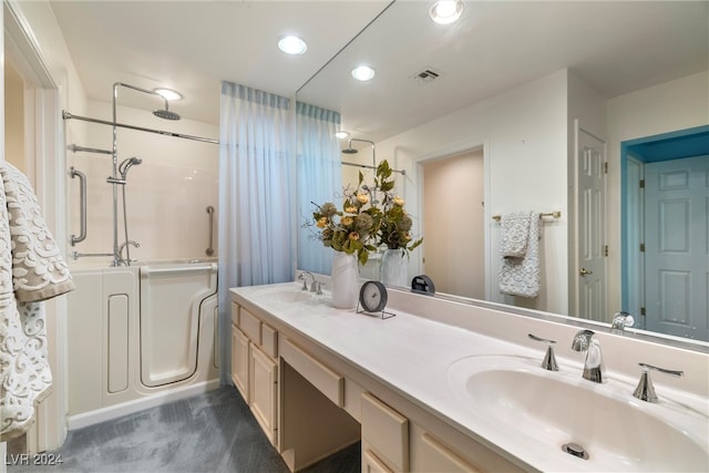 bathroom with vanity and  shower combination