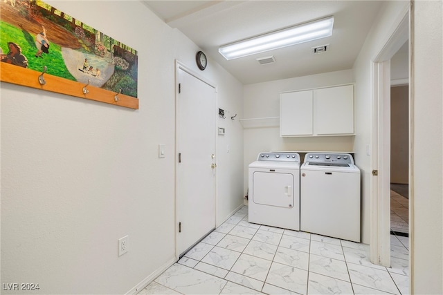 laundry room featuring cabinets and washing machine and clothes dryer