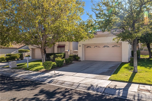 view of front of home with a front lawn and a garage