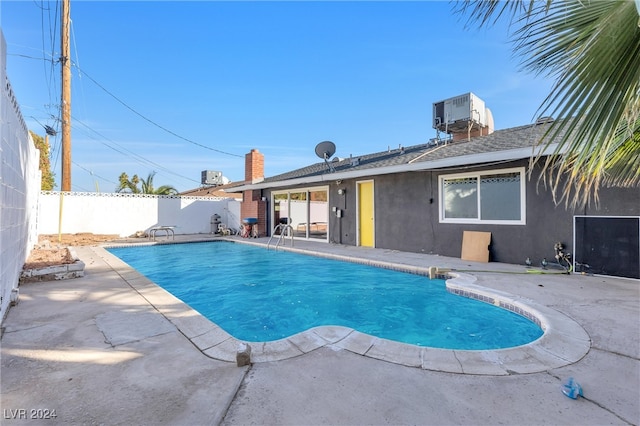 view of swimming pool with central AC and a patio area