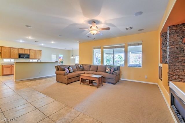 tiled living room with ceiling fan