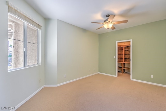 unfurnished room with light carpet and ceiling fan