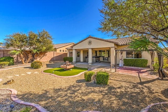 rear view of house with a patio