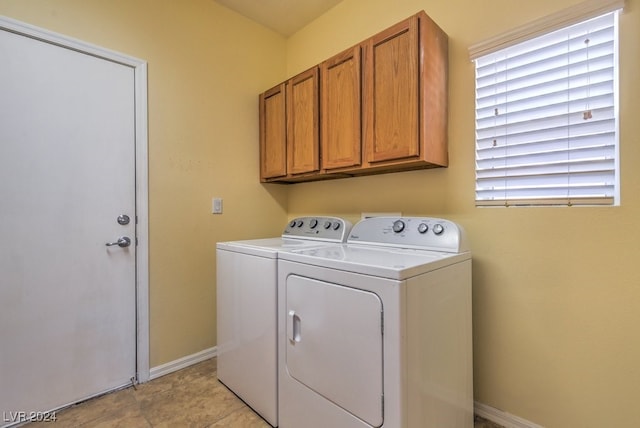 washroom with washer and clothes dryer, cabinets, and light tile patterned floors