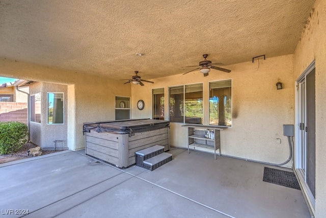 view of patio / terrace featuring ceiling fan and a hot tub