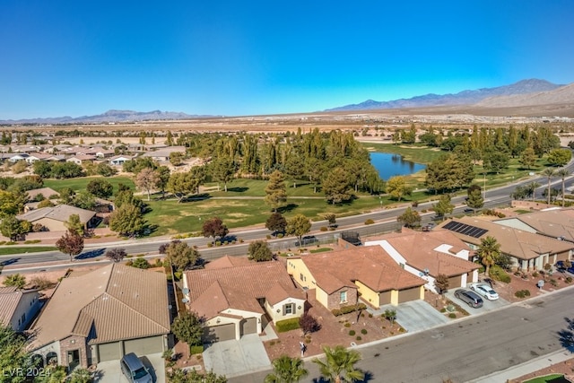 birds eye view of property with a water and mountain view