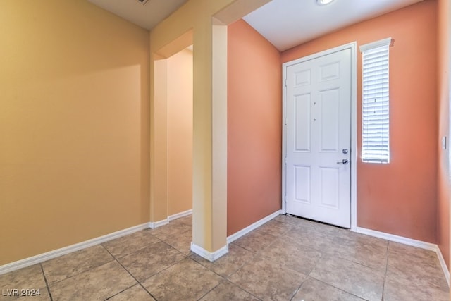 foyer entrance with light tile patterned floors