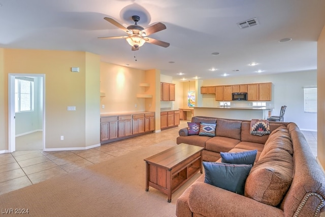 living room featuring light tile patterned flooring and ceiling fan