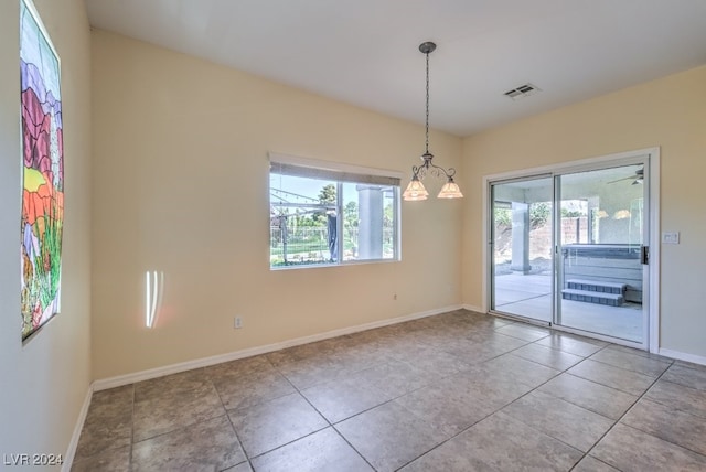 spare room with a healthy amount of sunlight and light tile patterned floors