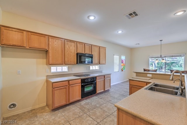 kitchen with black appliances, light tile patterned flooring, hanging light fixtures, an inviting chandelier, and sink