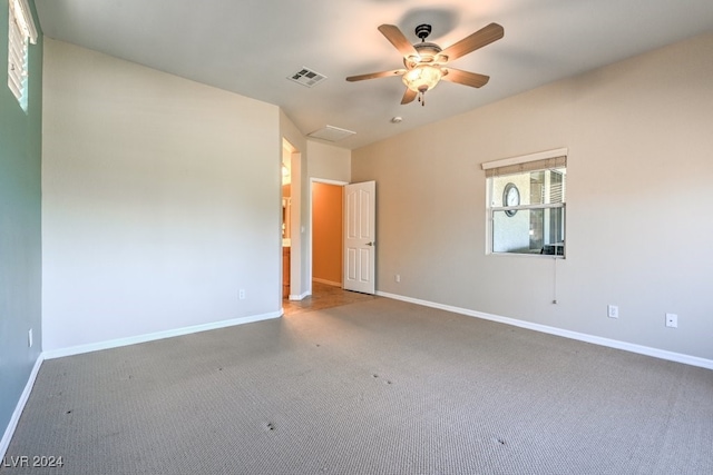 unfurnished room featuring ceiling fan and carpet floors