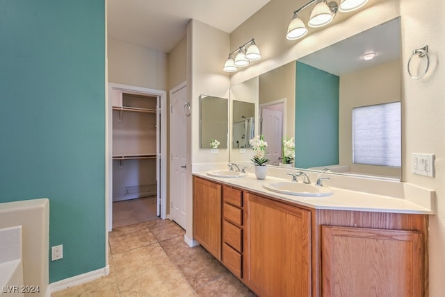 bathroom with vanity, tile patterned floors, and a bathtub