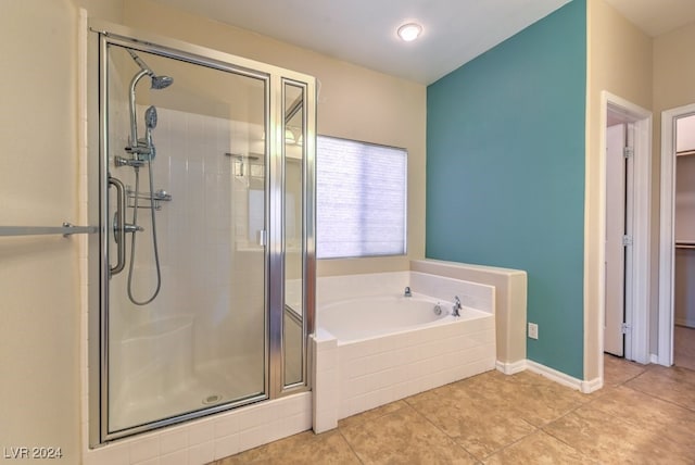 bathroom with tile patterned floors and shower with separate bathtub