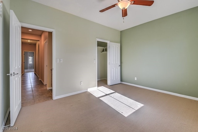 unfurnished bedroom featuring a closet, light carpet, and ceiling fan