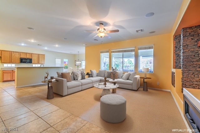 tiled living room featuring ceiling fan